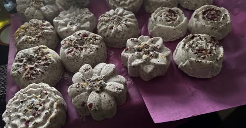 Valentine’s Day Self-Care Bundle featuring handcrafted bath fizzies in various floral shapes.